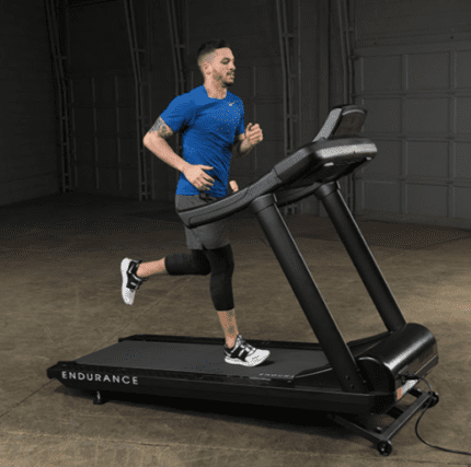 Man running on a black treadmill.