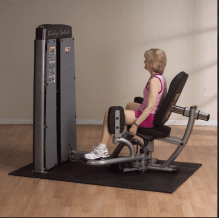 Woman using a Body-Solid hip abductor machine.