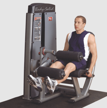 Man using a Body-Solid leg curl machine.