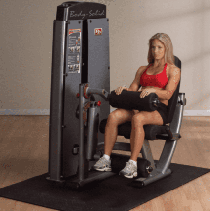 Woman exercising on a Body-Solid leg curl machine.