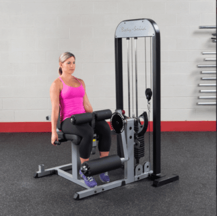 Woman exercising on a leg extension machine.