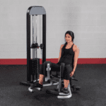 Woman using a leg extension machine.