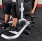 Person using a leg extension machine.