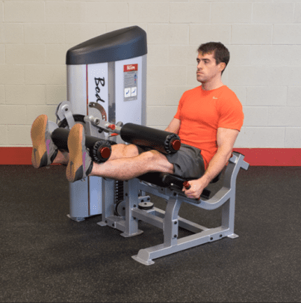 Man using leg extension machine.