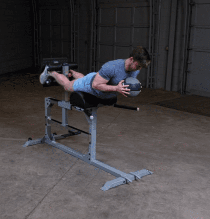 Man doing a back hyperextension exercise.