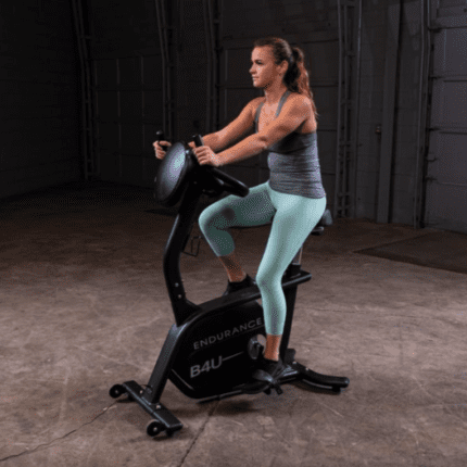 Woman exercising on an indoor cycling bike.