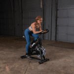 Woman exercising on a black stationary bike.
