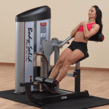 Woman exercising on a Body-Solid machine.