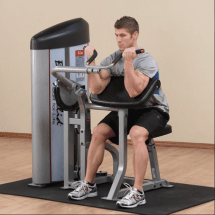 Man doing bicep curls on a gym machine.