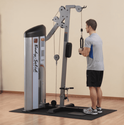 Man using a Body-Solid lat pulldown machine.