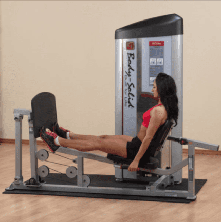 Woman exercising on a leg press machine.