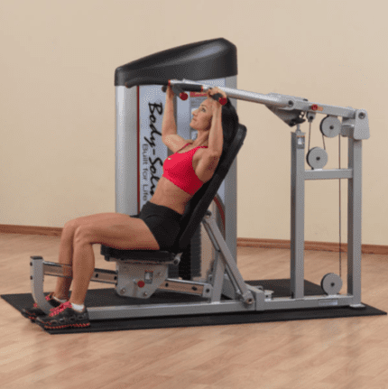 Woman doing chest press on gym machine.