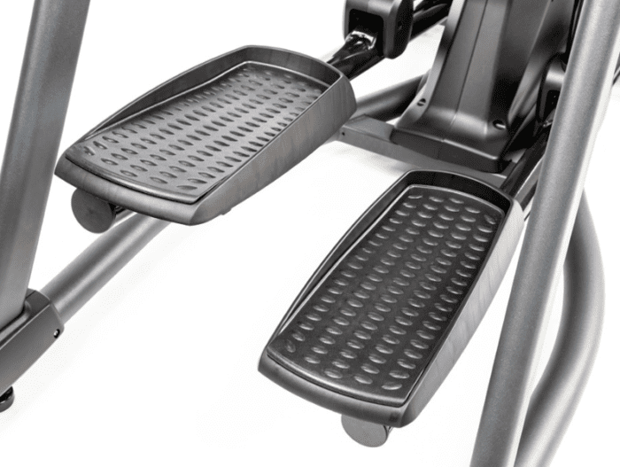 Closeup of elliptical machine pedals.