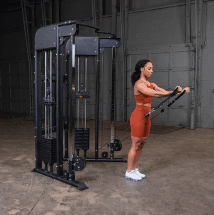 Woman working out on a cable machine.