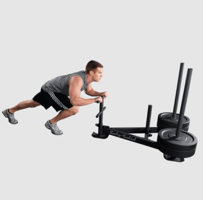 Man pulling a Body-Solid sled.