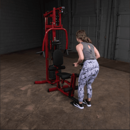 Woman working out on a home gym machine.