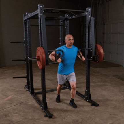 Man working out with a barbell in a gym.