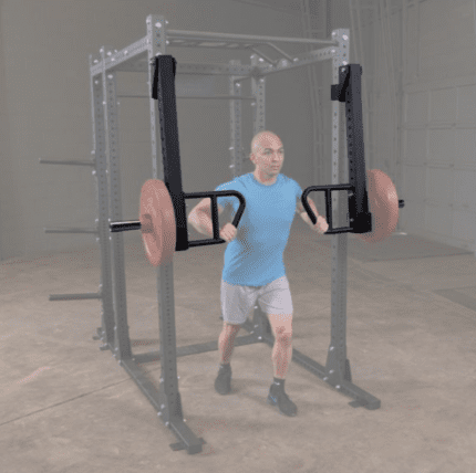 Man working out with a lat pulldown attachment.