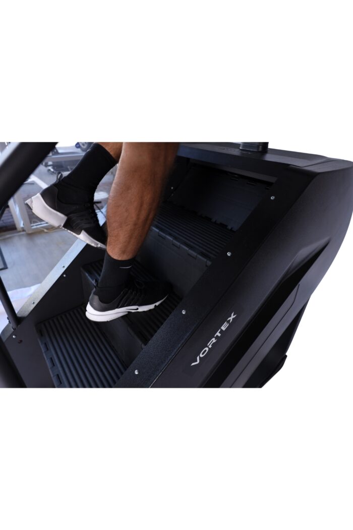 Person exercising on a black Vortex step machine.