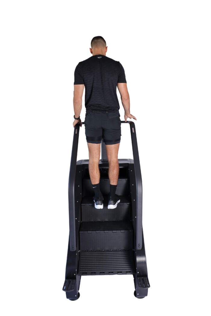 Man exercising on a stair climber machine.