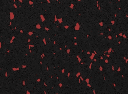 Red flecks on a black rubber surface.