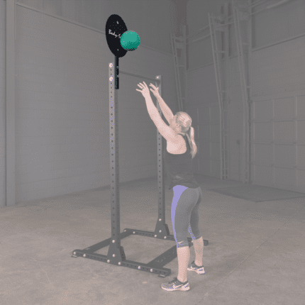 Woman exercising with a slam ball.