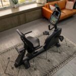 Black recumbent exercise bike indoors.