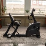 SportsArt recumbent exercise bike indoors.