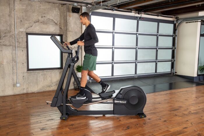 Man exercising on a SportsArt elliptical.