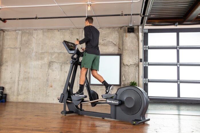 Man exercising on a SportsArt elliptical.