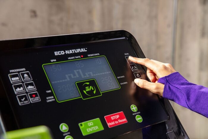 Person using Eco-Natural treadmill console.