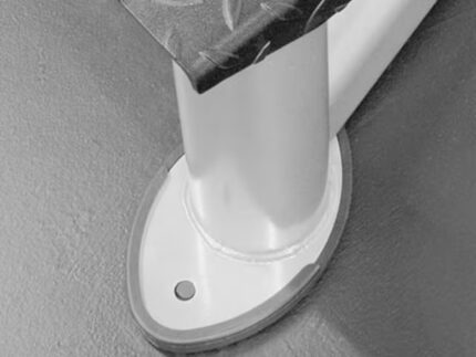 Metallic table leg with rounded base attachment.