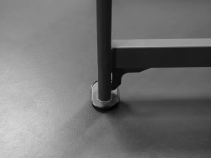 Table leg on smooth, grey floor surface.