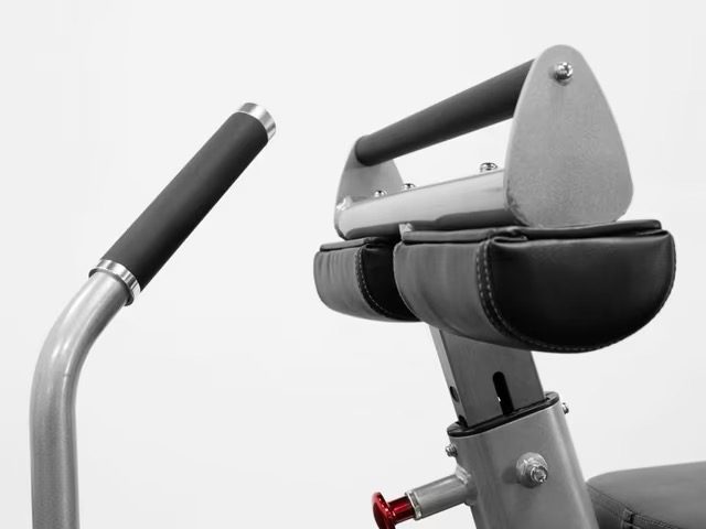 Exercise equipment handle and padded support close-up. Exercise equipment handle and padded support close-up.