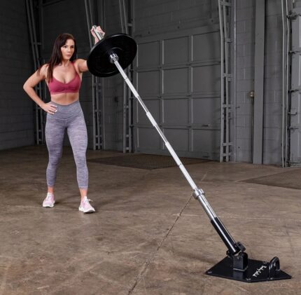 Woman exercising with landmine barbell setup.