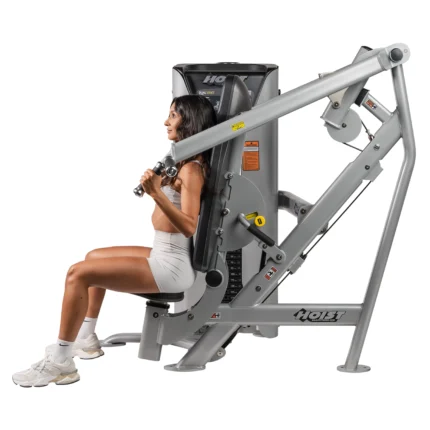 Woman using chest press exercise machine.