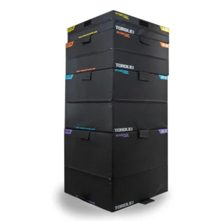 Stacked black fitness boxes with colorful labels.