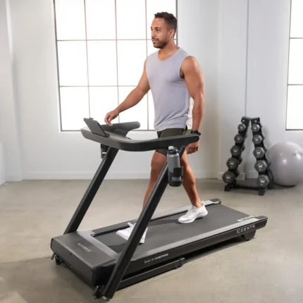 Man walking on a treadmill indoors.