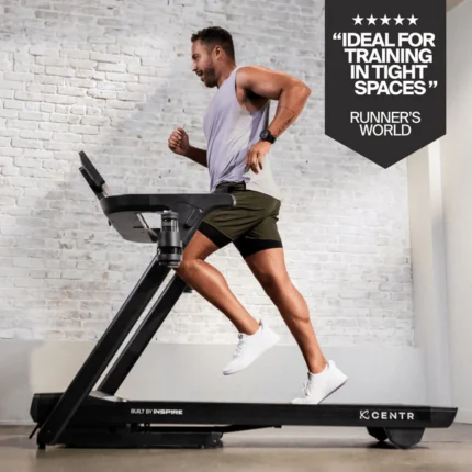 Man running on a treadmill indoors.
