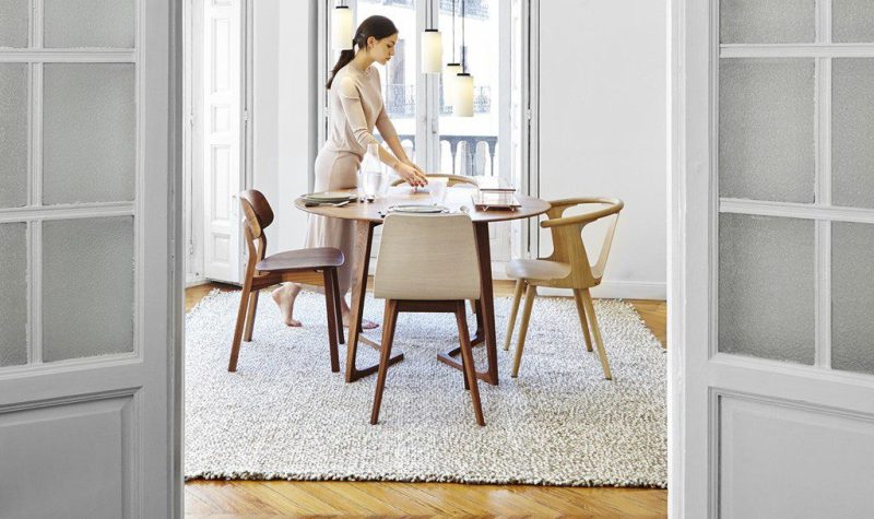 wd-blog-2 Woman setting table in modern dining room.