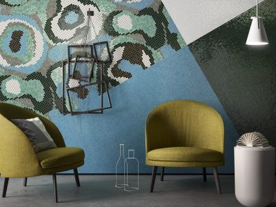 Mosaic tiled wall with two chairs and a lamp.