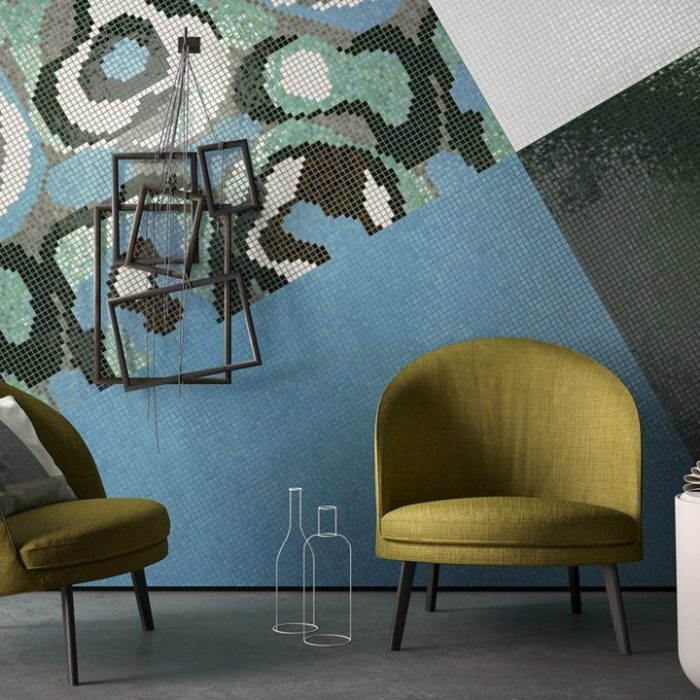 Mosaic tiled wall with two chairs and a lamp.