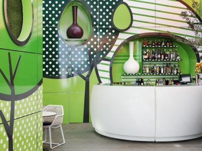 White bar with green and white wall art.
